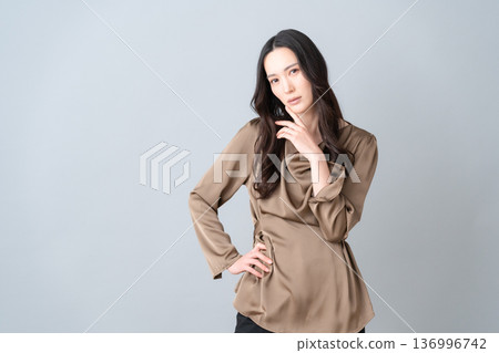 Female beauty doing skin care on a gray background Female beauty doing skin care on a gray background 136996742