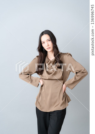 Female beauty doing skin care on a gray background 136996745