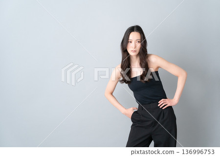Beauty image of a woman doing skin care on a gray background Beauty image of a woman doing skin care on a gray background 136996753