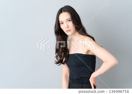 Beauty image of a woman doing skin care on a gray background Beauty image of a woman doing skin care on a gray background 136996758