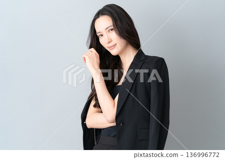 Beauty image of a woman doing skin care on a gray background 136996772