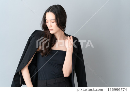 Beauty image of a woman doing skin care on a gray background Beauty image of a woman doing skin care on a gray background 136996774