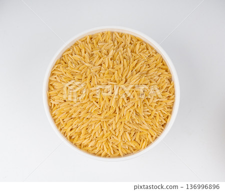 Raw orzo pasta, risoni or kritharaki pile 136996896