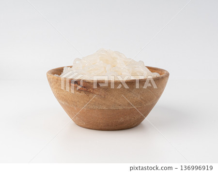 Shirataki or konnyaku pasta in wood bowl isolated. Konjak jelly noodles, Japanese zero calorie sirataki Shirataki or konnyaku pasta in wood bowl isolated. Konjak jelly noodles, Japanese zero calorie sirataki 136996919