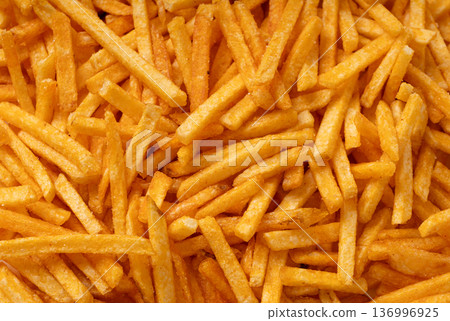 Fried chips sticks texture background, finger potato ketchup flavored chips pattern, shoestring fries Fried chips sticks texture background, finger potato ketchup flavored chips pattern, shoestring fries 136996925