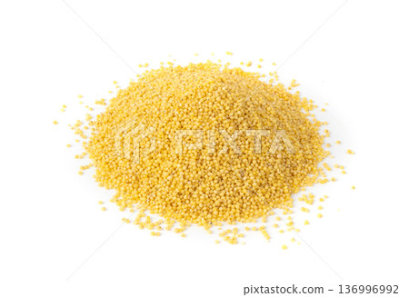 Raw millet grains pile isolated. Little yellow cereal, natural foxtail small seeds Raw millet grains pile isolated. Little yellow cereal, natural foxtail small seeds 136996992
