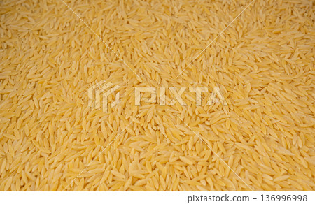 Raw orzo pasta, risoni or kritharaki pile Raw orzo pasta, risoni or kritharaki pile 136996998