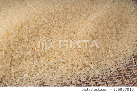 White parboiled rice grains. Dry uncooked ponni rice, small organic basmati White parboiled rice grains. Dry uncooked ponni rice, small organic basmati 136997016