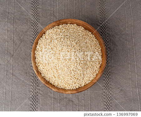 Sesame seeds pile closeup, white small benne grains. Sesamum indicum fruits Sesame seeds pile closeup, white small benne grains. Sesamum indicum fruits 136997069