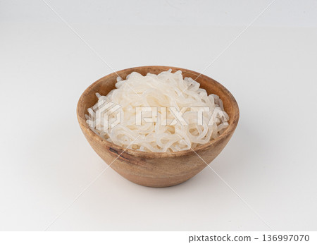 Shirataki or konnyaku pasta in wood bowl isolated. Konjak jelly noodles, Japanese zero calorie sirataki Shirataki or konnyaku pasta in wood bowl isolated. Konjak jelly noodles, Japanese zero calorie sirataki 136997070