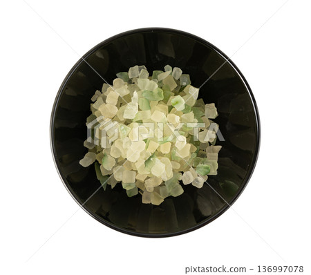 Candied citrus peel isolated. Diced succade from the citron or citrus medica Candied citrus peel isolated. Diced succade from the citron or citrus medica 136997078