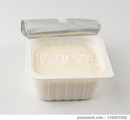 Yogurt cup isolated, yoghurt with orange fruits pieces in plastic pot, milk pudding container Yogurt cup isolated, yoghurt with orange fruits pieces in plastic pot, milk pudding container 136997088