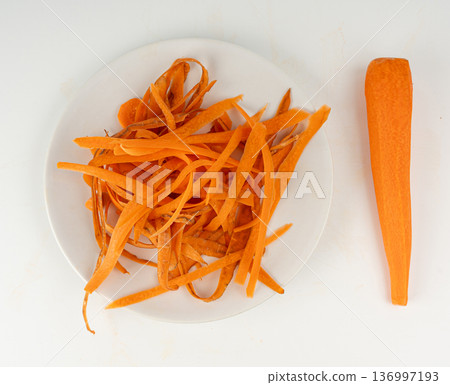 Carrot skins, vegetable peelings isolated on a white background 136997193