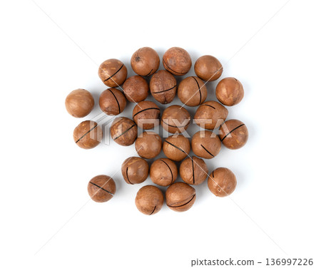Macadamia nuts isolated. Natural raw peeled macadamia seeds and shells 136997226