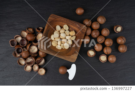 Macadamia nuts. Natural raw peeled macadamia seeds and shells 136997227
