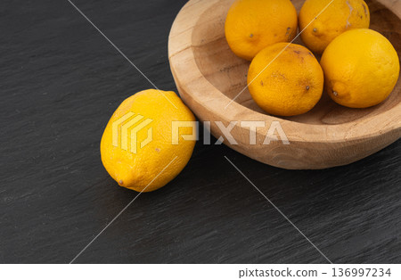 Old dried lemons. Fruits with darkened skins 136997234
