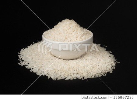 Grated coconut powder. Dry coco flakes pile, shredded desiccated coconut, tropical fruit chips Grated coconut powder. Dry coco flakes pile, shredded desiccated coconut, tropical fruit chips 136997253