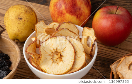 Dry apple slices, dried apple chips, healthy fruit snack Dry apple slices, dried apple chips, healthy fruit snack 136997263