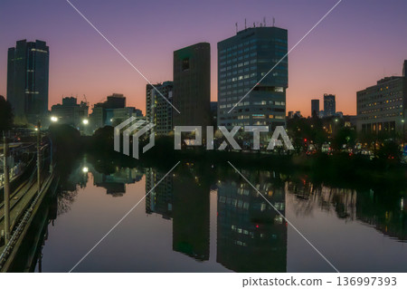 The Ichigaya Outer Moat and buildings reflected on the water at dusk The Ichigaya Outer Moat and buildings reflected on the water at dusk 136997393