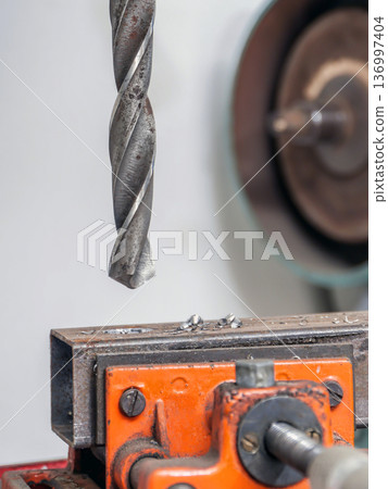 Drilling in metal piece Drilling in metal piece 136997404