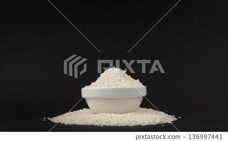 Grated coconut powder. Dry coco flakes pile, shredded desiccated coconut, tropical fruit chips 136997441