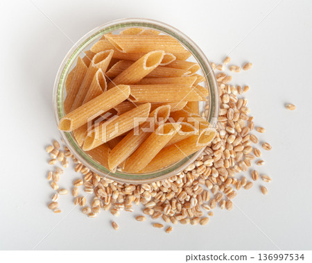 Raw Brown Pasta, Wholegrain Penne, Dry Whole Grain Noodle, Raw Spelt Macaroni, Healthy Italy Food Raw Brown Pasta, Wholegrain Penne, Dry Whole Grain Noodle, Raw Spelt Macaroni, Healthy Italy Food 136997534