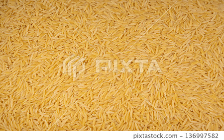 Raw orzo pasta, risoni or kritharaki pile 136997582