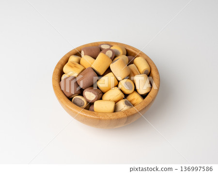 Filled dog biscuits, crackers isolated, soft crunchy pet treats pile, flavored small canine cookie 136997586