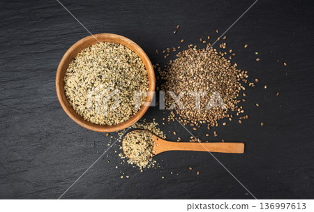 Shelled hemp seeds pile, peeled cannabis grains, marijuana kernels without peel 136997613