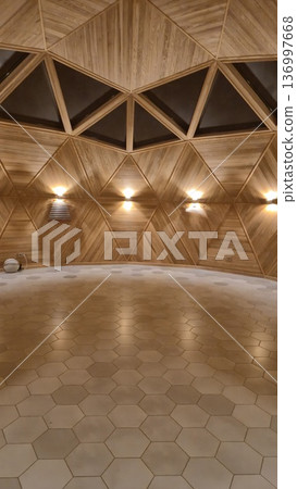 Warm light illuminates the triangular wooden panels inside a geometric dome structure with hexagonal floor tiles, modern architecture, peaceful retreat. 136997668