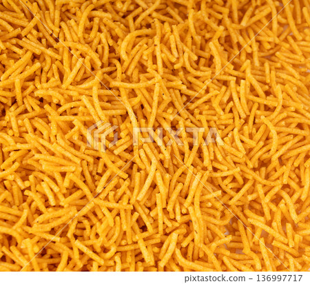 Aloo bhujia indian snack isolated. Crispy potato and chickpea flour strips, alu bhujiya sev Aloo bhujia indian snack isolated. Crispy potato and chickpea flour strips, alu bhujiya sev 136997717