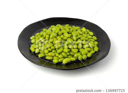 Edamame beans isolated. Green soy bean pile, cooked young soybean, boiled Japanese pea 136997725