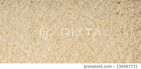 Grated coconut powder. Dry coco flakes pile, shredded desiccated coconut, tropical fruit chips Grated coconut powder. Dry coco flakes pile, shredded desiccated coconut, tropical fruit chips 136997731