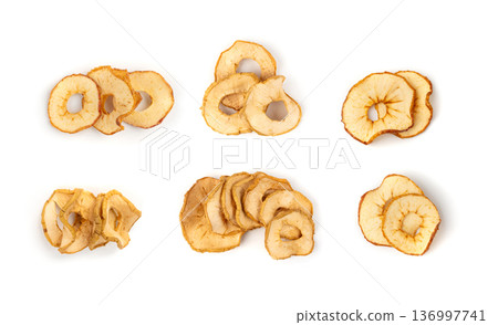 Dry apple slices isolated, dried apple chips, healthy fruit snack Dry apple slices isolated, dried apple chips, healthy fruit snack 136997741