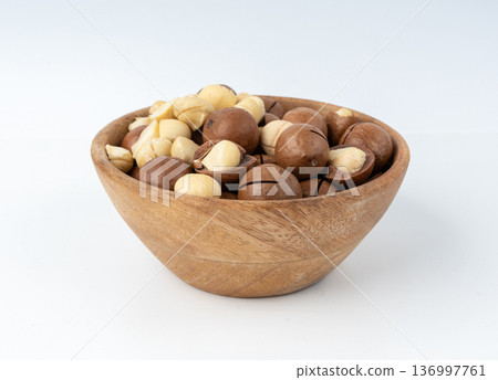 Macadamia nuts isolated. Natural raw peeled macadamia seeds and shells 136997761