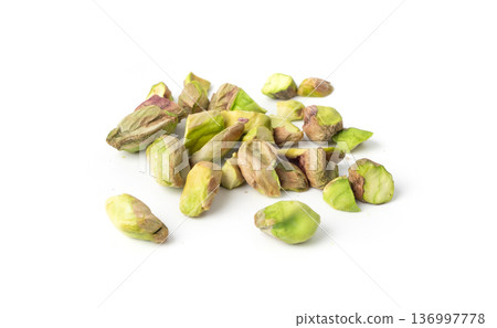 Fried salt pistachio nuts isolated. Baked pistachios pile, roasted green pistache fruits on white Fried salt pistachio nuts isolated. Baked pistachios pile, roasted green pistache fruits on white 136997778
