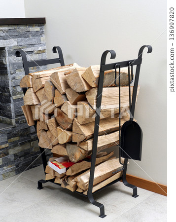 Firewood on metal stand Firewood on metal stand 136997820