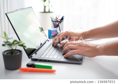 Man using laptop with blank screen Man using laptop with blank screen 136997853