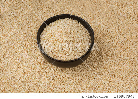 Sesame seeds pile closeup, white small benne grains. Sesamum indicum fruits Sesame seeds pile closeup, white small benne grains. Sesamum indicum fruits 136997945