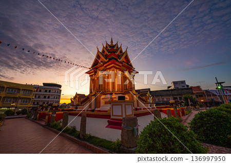 Dawn Illumination of Pakse Shrine Under Drifting Clouds 136997950
