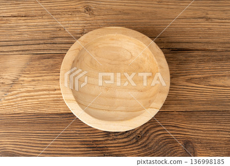Empty wood bowl on table, plate on wooden tabletop, light rustic dish mockup, eco bio kitchen Empty wood bowl on table, plate on wooden tabletop, light rustic dish mockup, eco bio kitchen 136998185