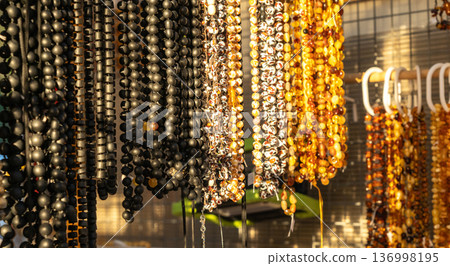 Amber stones market, polished orange gemstones closeup, natural Baltic amber gems jewelry store 136998195