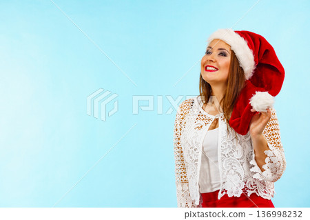 Smiling woman in christmas santa hat Smiling woman in christmas santa hat 136998232