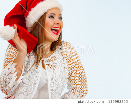 Smiling woman in christmas santa hat Smiling woman in christmas santa hat 136998233