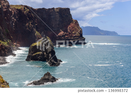 Rugged basalt coast Ponta de Sao Lourenco Madeira meets open Atlantic dark rocks in restless water Rugged basalt coast Ponta de Sao Lourenco Madeira meets open Atlantic dark rocks in restless water 136998372