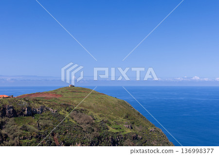 Ponta do Pargo Madeira headland lone house on summit above sheer green cliffs dropping into Atlantic Ponta do Pargo Madeira headland lone house on summit above sheer green cliffs dropping into Atlantic 136998377