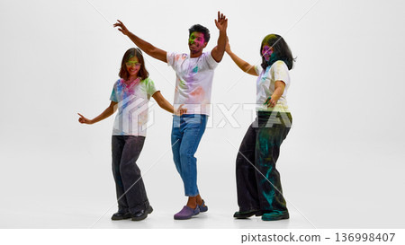 Friends expressing cultural identity through Holi festival dance. Friends expressing cultural identity through Holi festival dance. 136998407