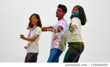 Multicultural friends celebrating Holi festival isolated on white. Multicultural friends celebrating Holi festival isolated on white. 136998409