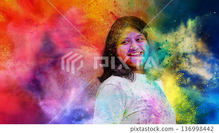 Woman smiling in colorful powder cloud during Holi festival. 136998442