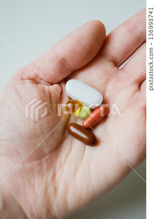 Colorful pills, tablets, capsules in woman hand close up with . Healthcare and medicine. Colorful pills, tablets, capsules in woman hand close up with . Healthcare and medicine. 136998741